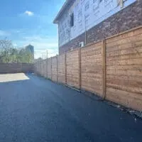 Custom built privacy fence beside drive way